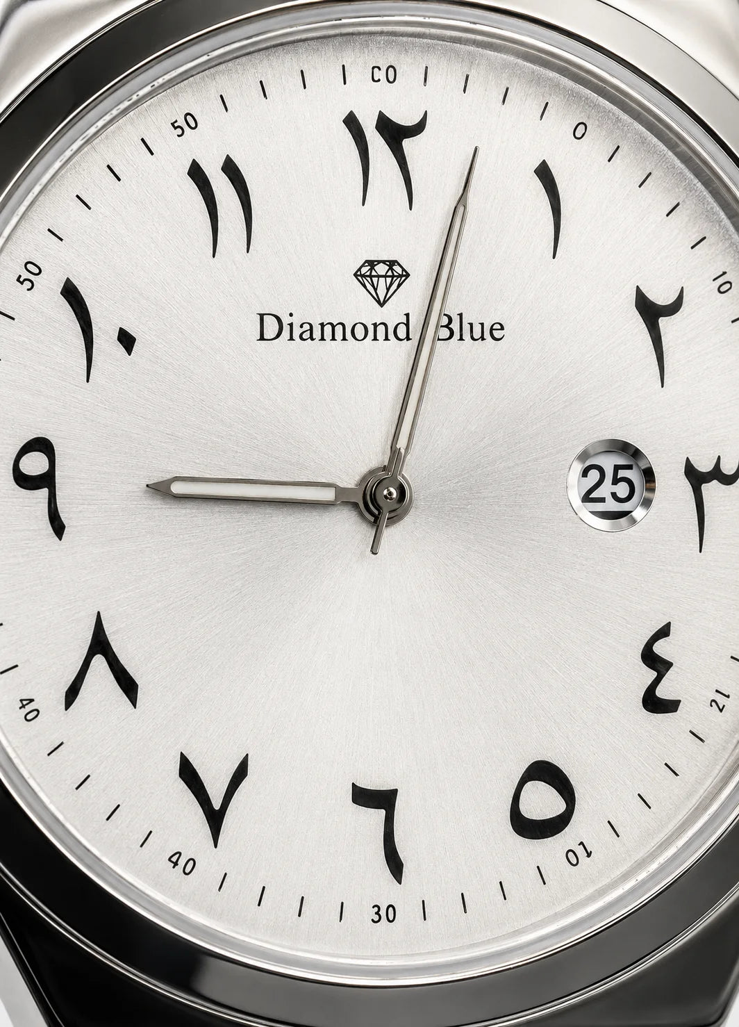 Close-up of Diamond Blue DB-010 silver-white dial with black Arabic numerals, Diamond Blue logo and date display.